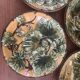 Four antique dessert plates in majolica with vine decoration.