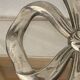 Lancel trivet, bow and ribbon, silver-plated metal