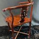 Corner armchair in solid wood with carved floral decoration featuring a bird.