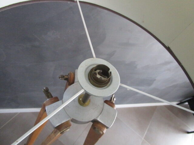 Old floor lamp on surveyor tripod