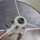 Old floor lamp on surveyor tripod