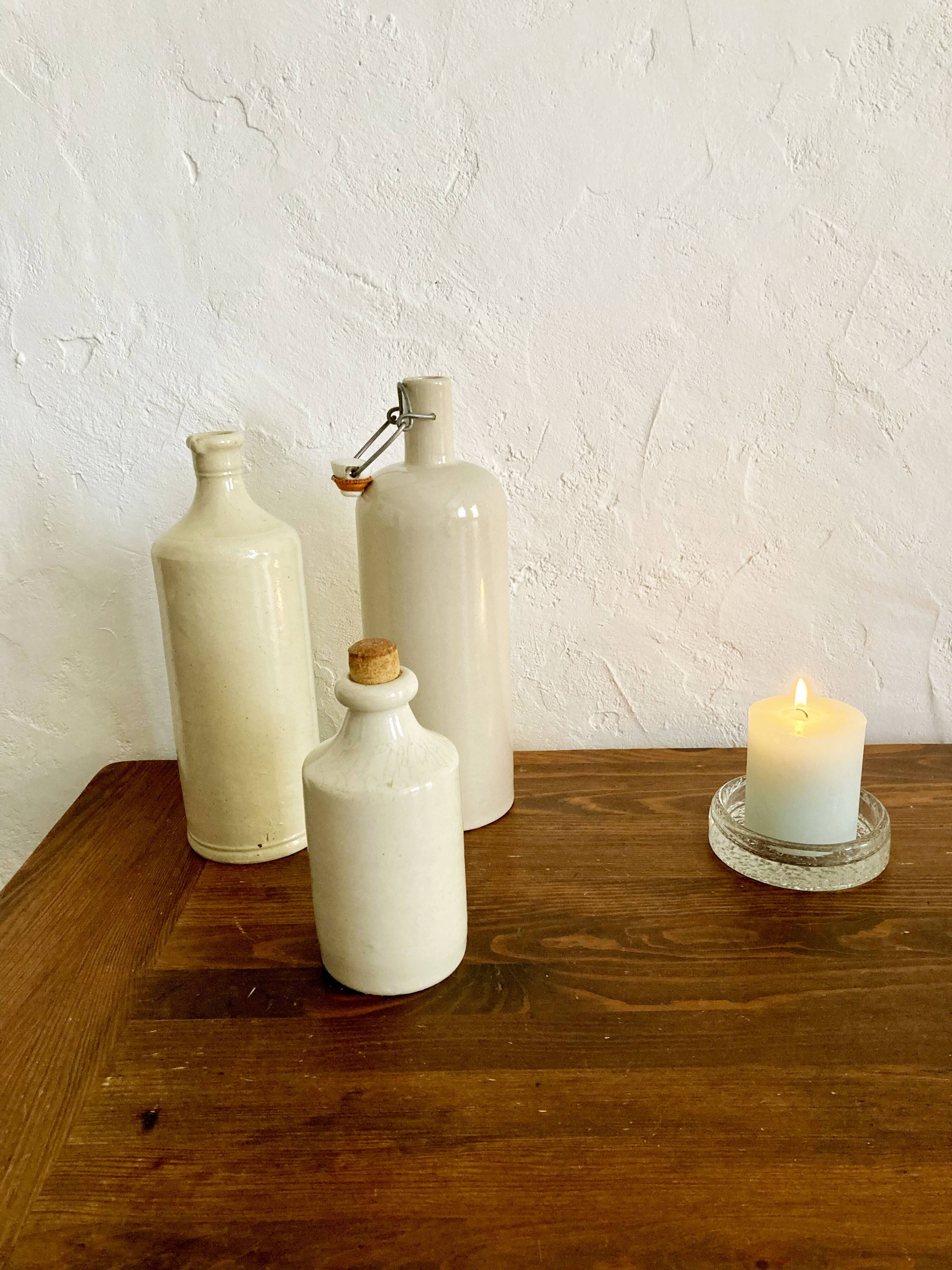 Trio of creamy white glazed stoneware bottles