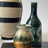 Ceramic vase with a glazed blue/green finish.