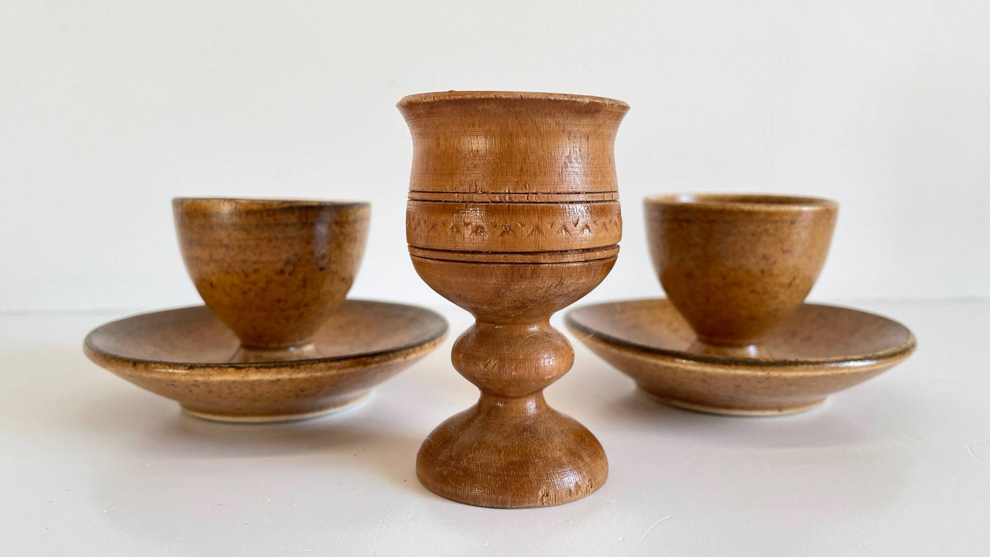 Trio of vintage ceramic and wood egg cups
