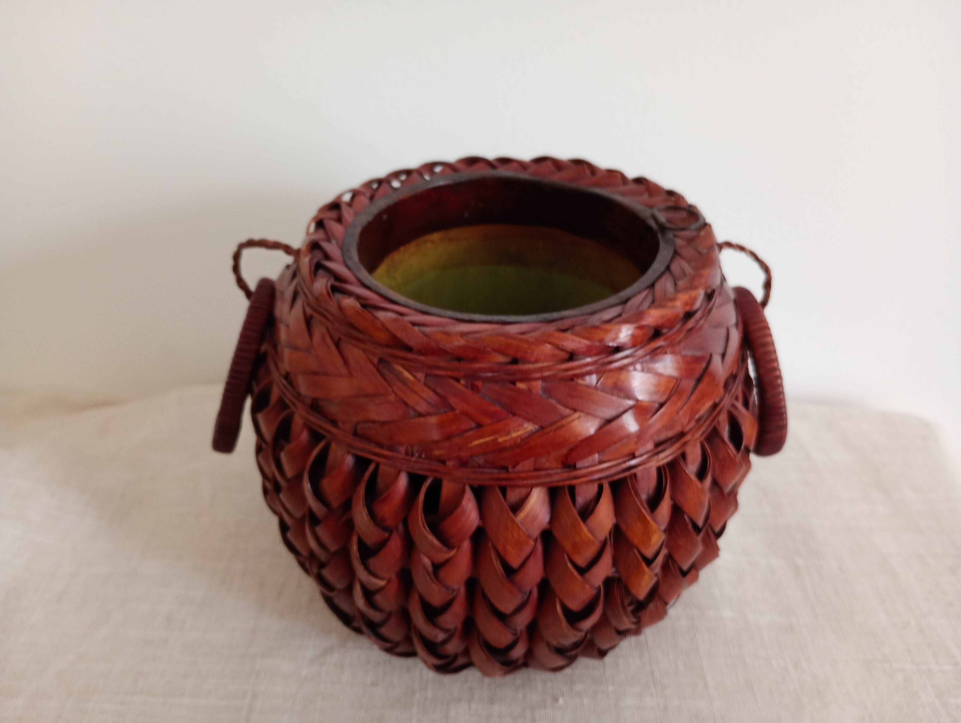 Japanese vase made of woven bamboo. Ikebana.