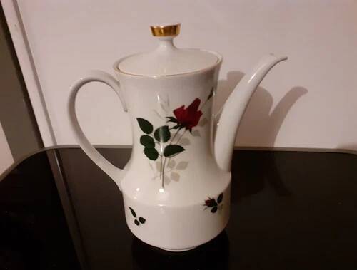White porcelain coffee service of 3 pieces with a rose design.