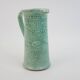 Large green ceramic pitcher with leopard enamel