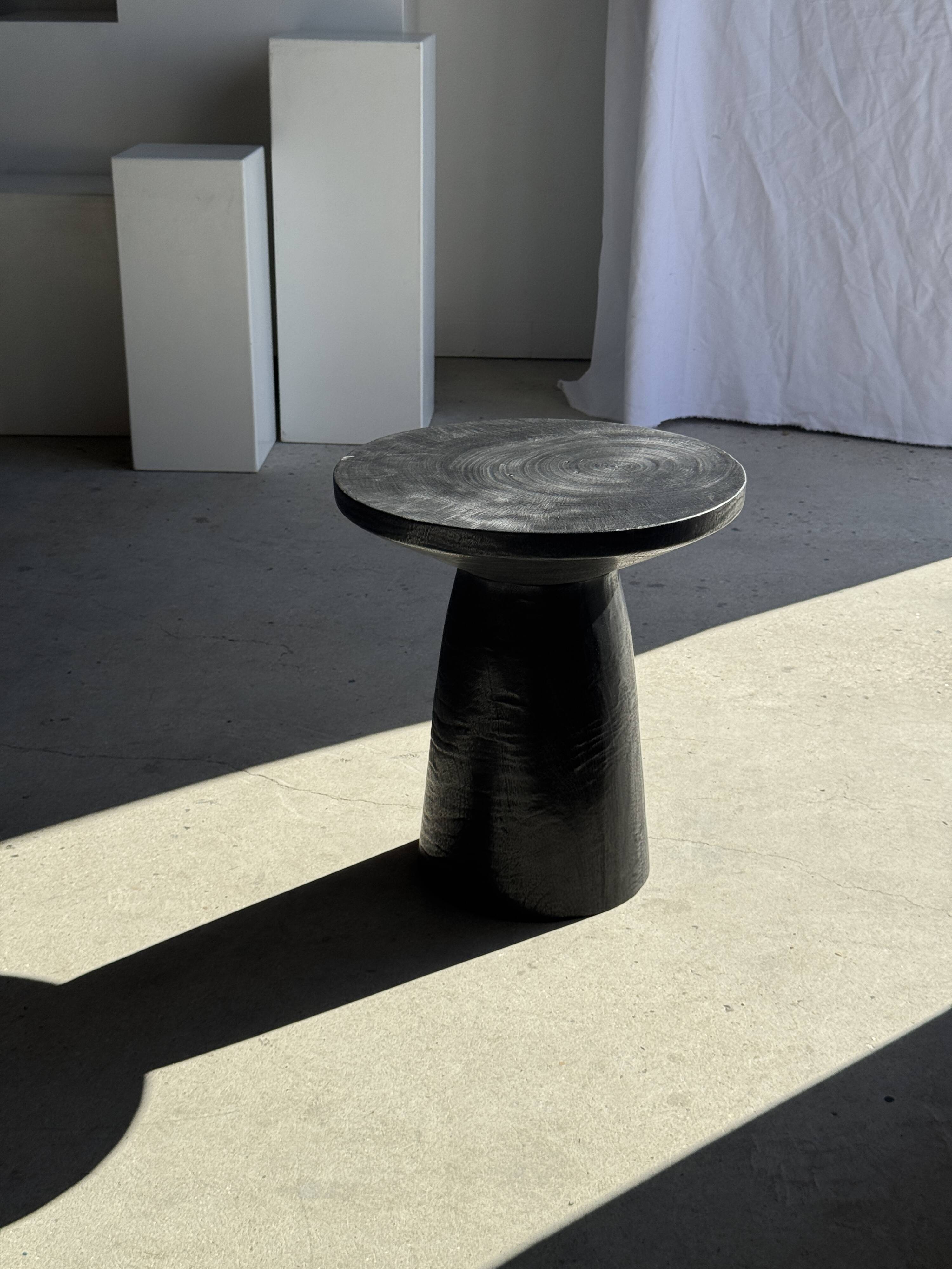 Black solid mango side table (monoxyle) with conical legs