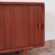 Teak enfilade, sliding doors, black faux leather top, 1970s.