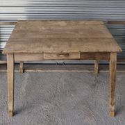 Old farmhouse table with its 2 extensions and raised legs.