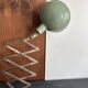 Old extendable accordion lamp in celadon green, workshop spirit.