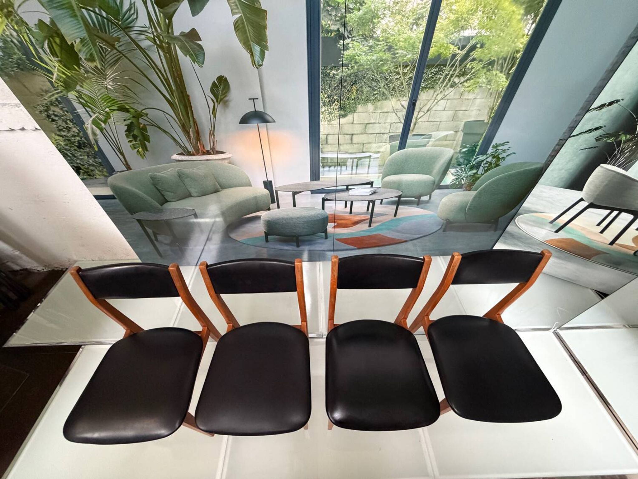 4 Scandinavian chairs in teak and black faux leather.