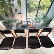 4 Scandinavian chairs in teak and black faux leather.