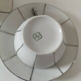 Two Art Deco porcelain cups and saucers with silver trim.