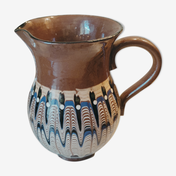 Pitcher with ethnic decorations