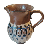 Pitcher with ethnic decorations