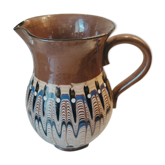 Pitcher with ethnic decorations