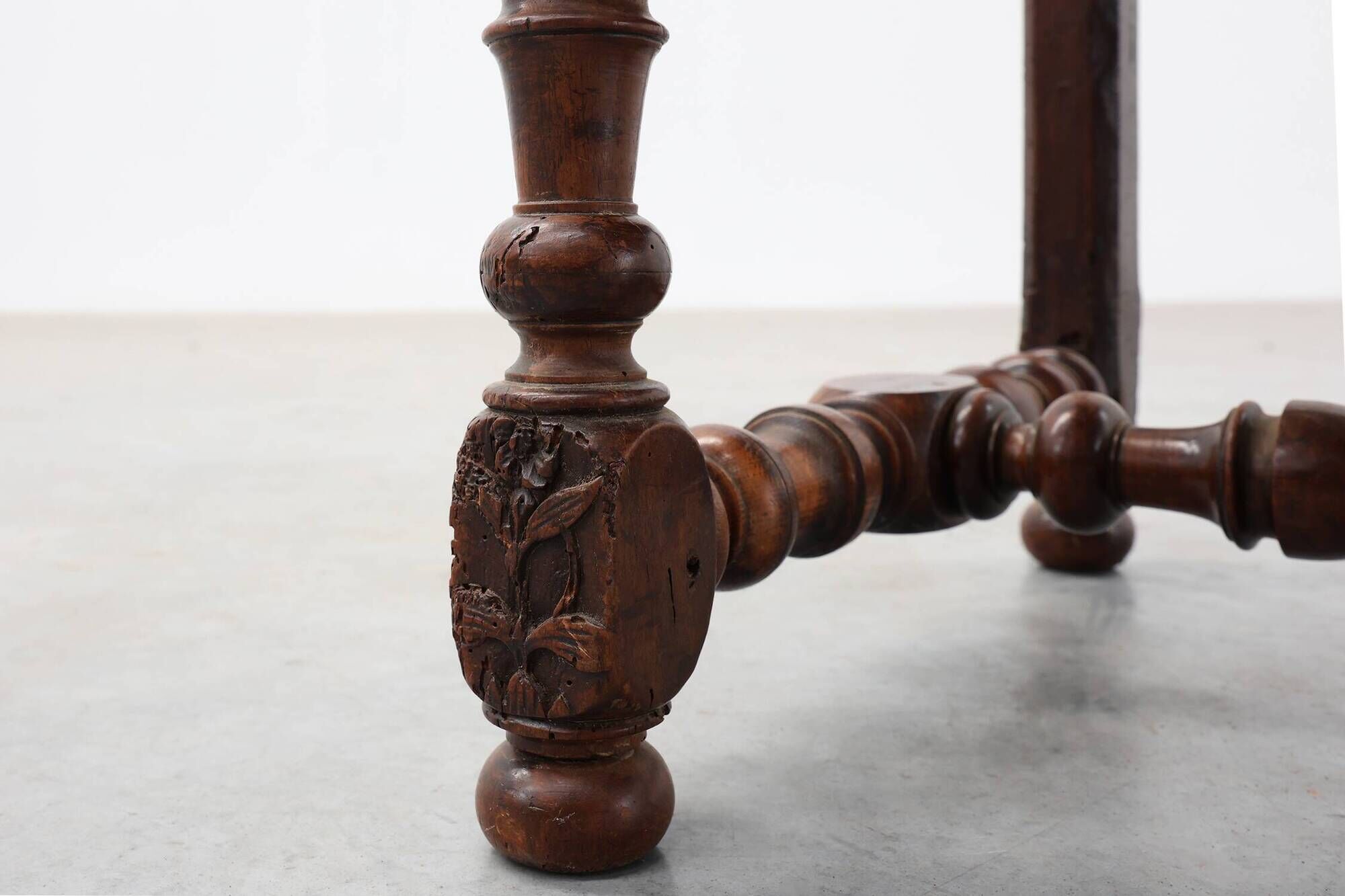 Louis XIII walnut stool with carved turned stretchers and upholstered seat