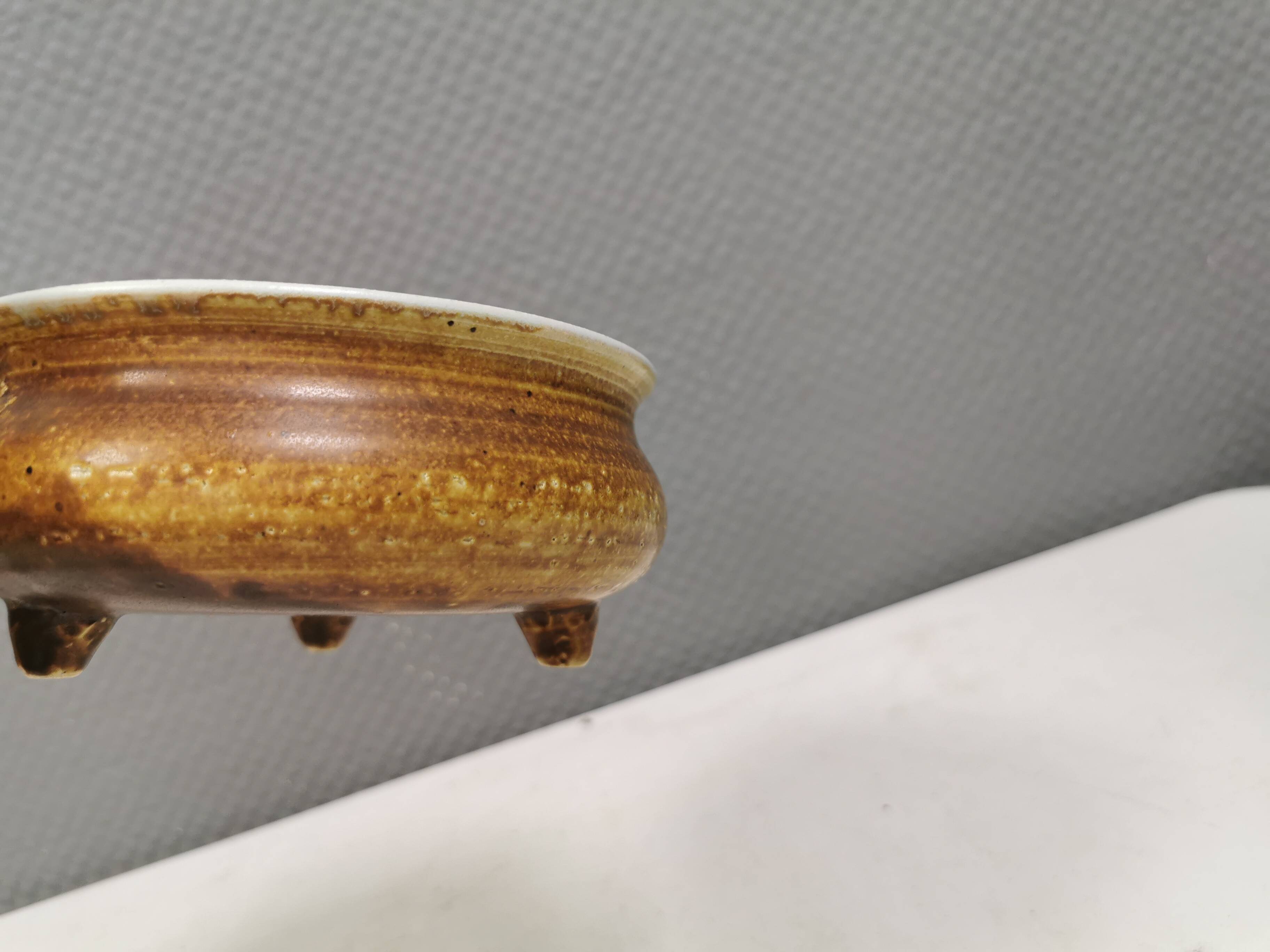 Small ceramic bowl with handle, in golden colours. Danish 1960-70s