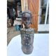 African statue of a woman, made of wood, brass, beads, and seashells.
