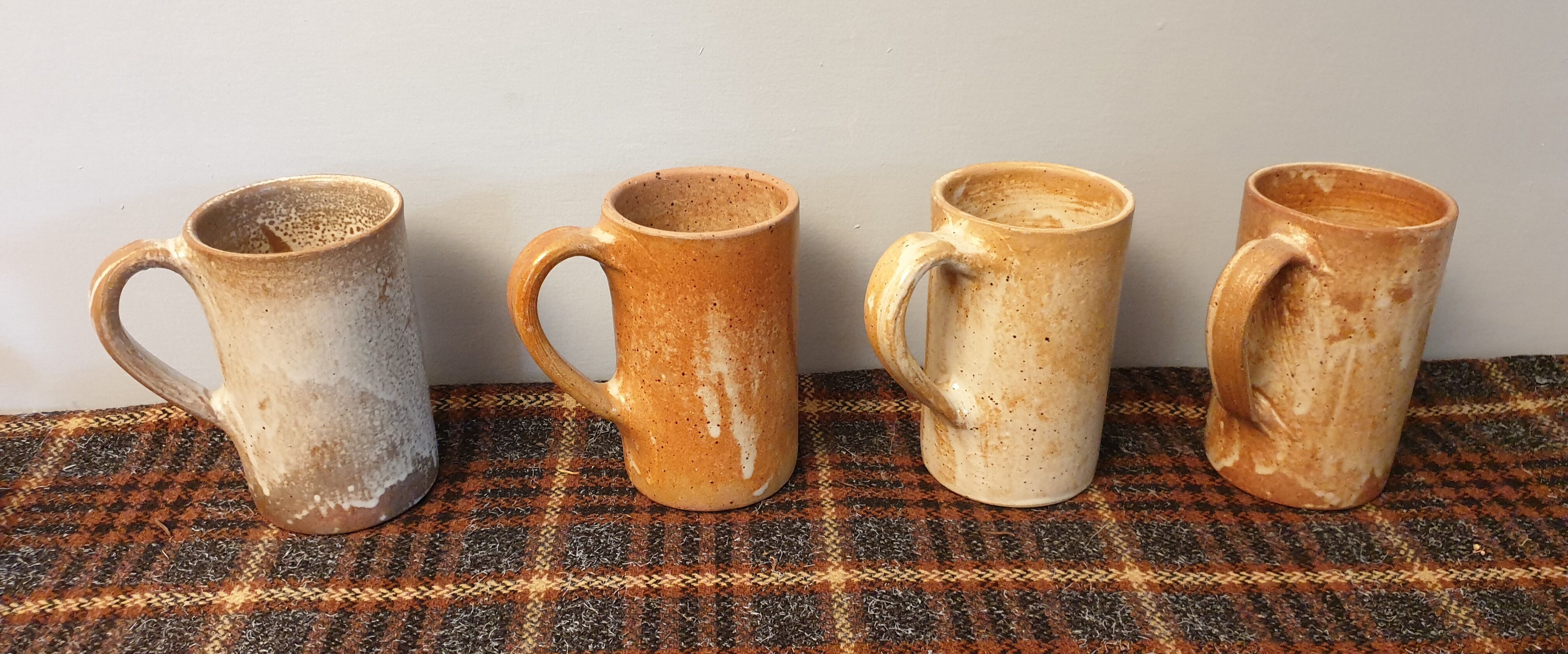 Suite of 4 sandstone mugs