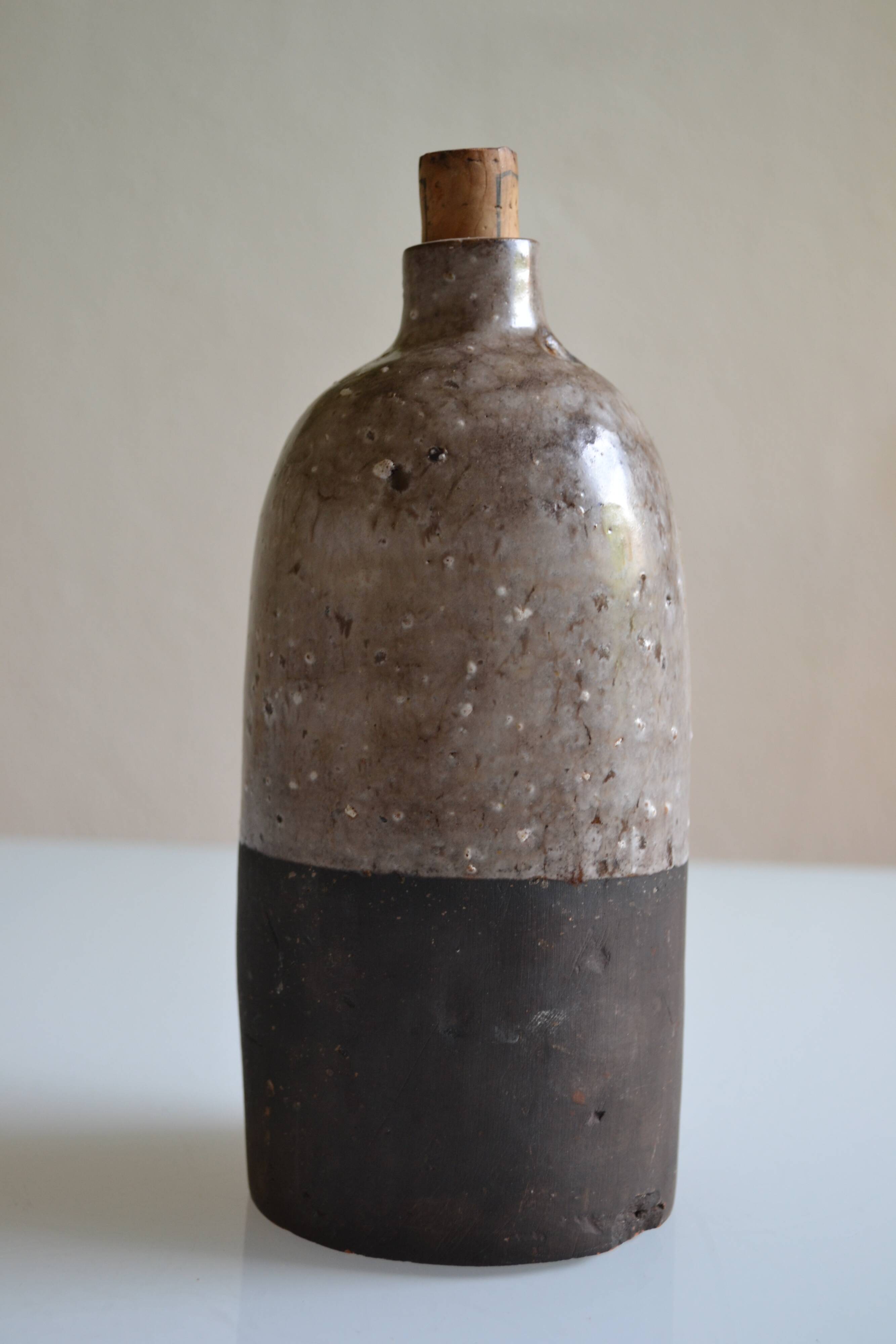 Ceramic bottle vase with a fish signature to be identified.