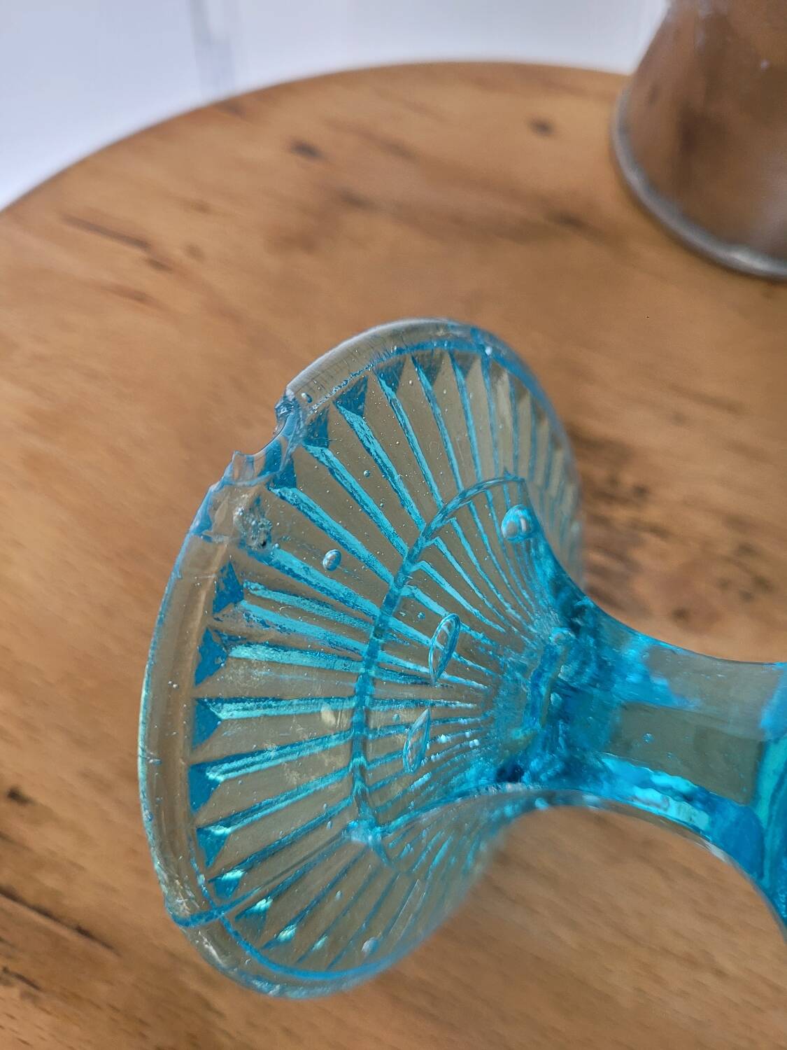 Plate on blue glass pedestal