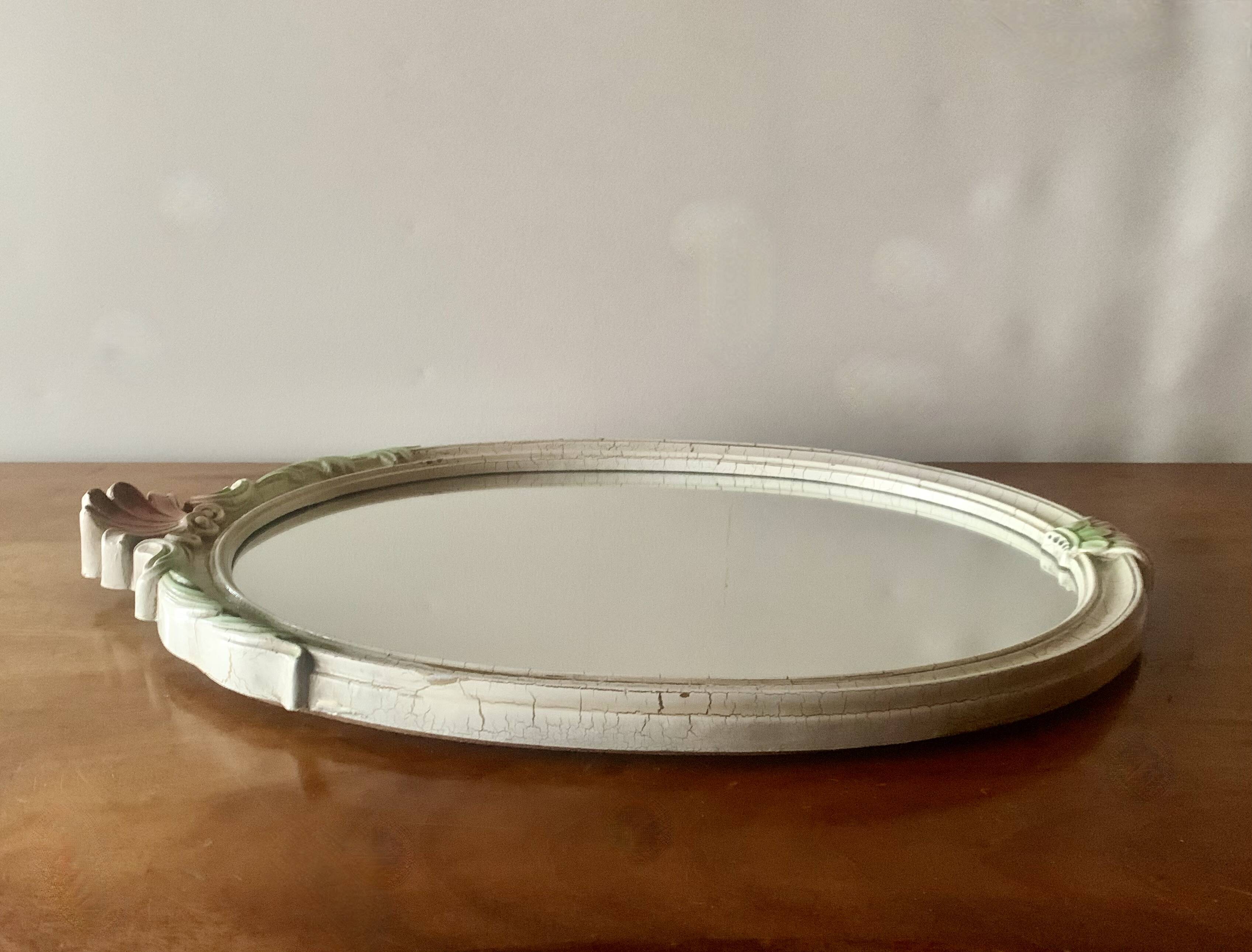 Vintage oval mirror in carved wood in pastel tones