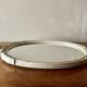 Vintage oval mirror in carved wood in pastel tones