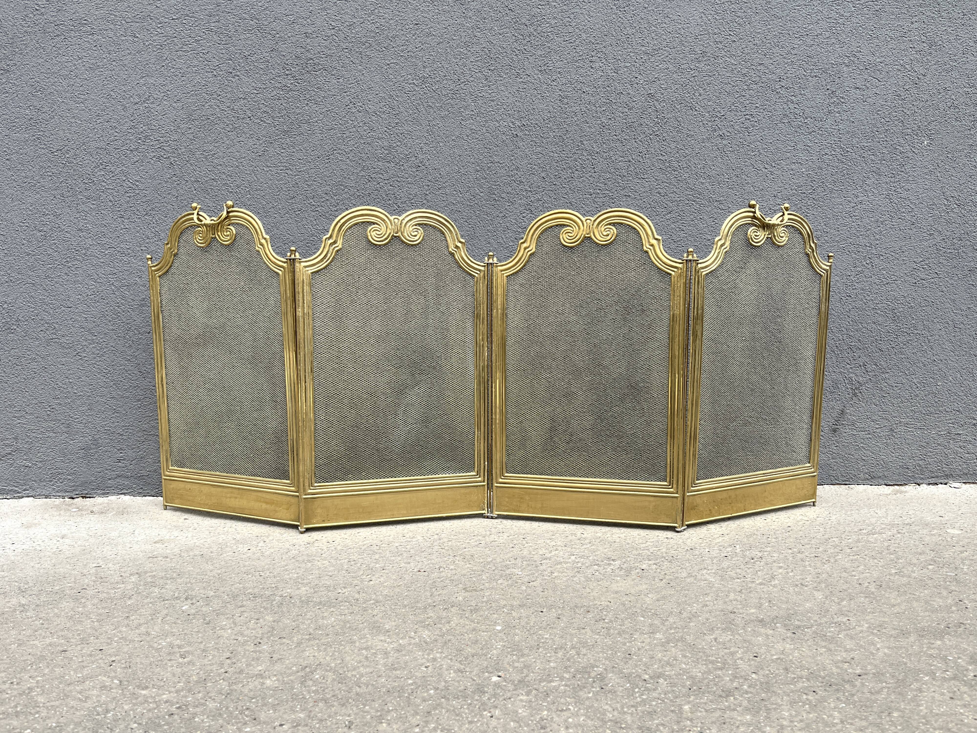 Antique brass fireplace screen from 1920, vintage spark guard.
