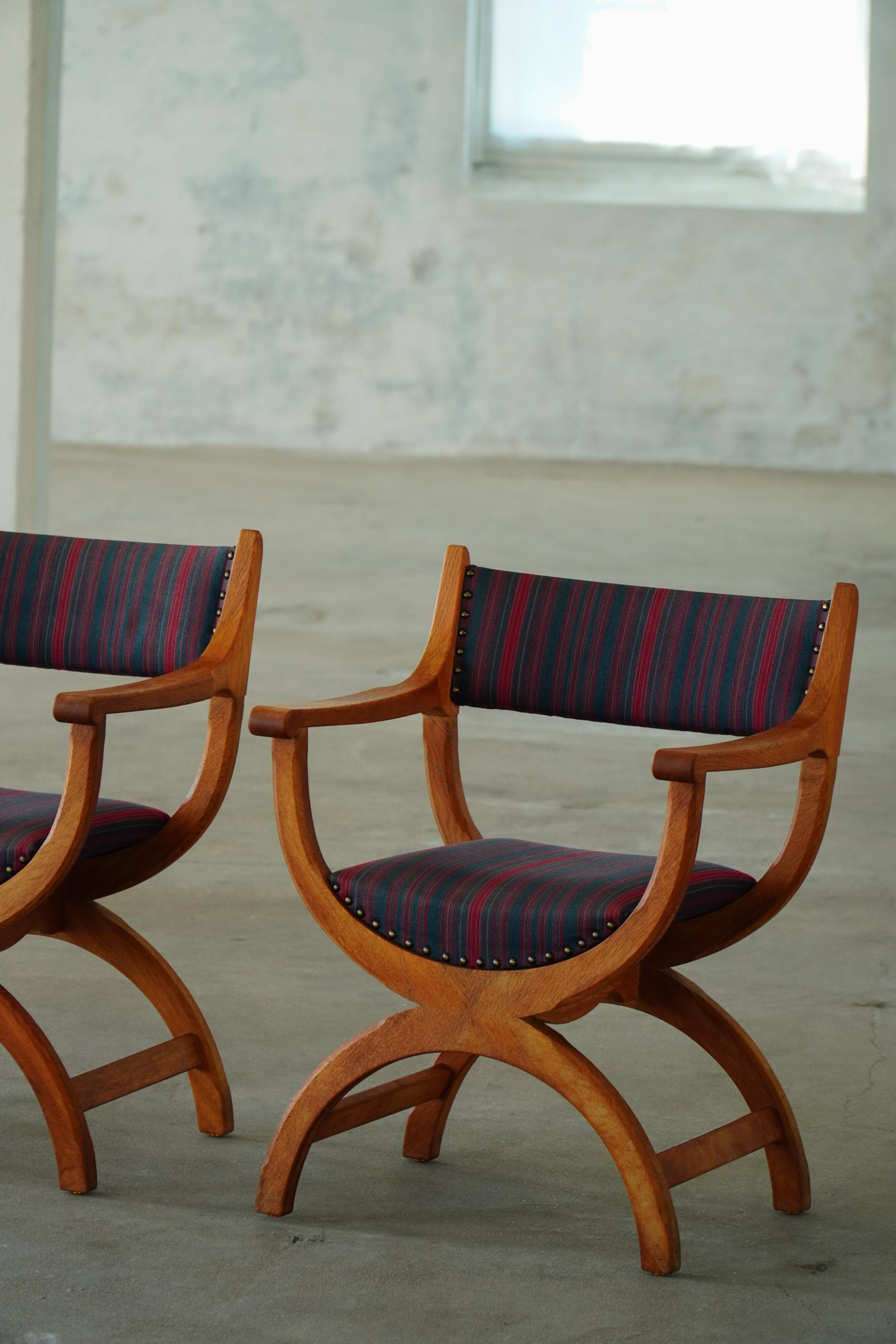 Henning Kjærnulf, pair of oak armchairs, model "Kurul", Danish modern style, 1960s.