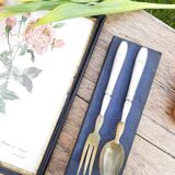 Corn and silver metal salad cutlery