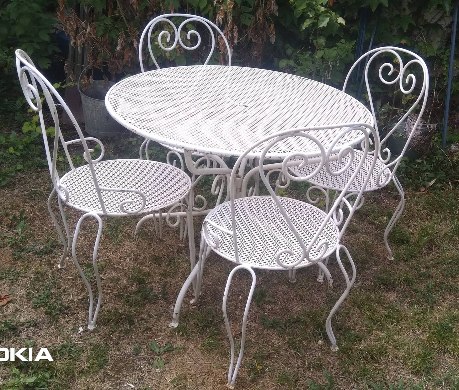 Mategot-style perforated wrought iron garden furniture with table and armchairs