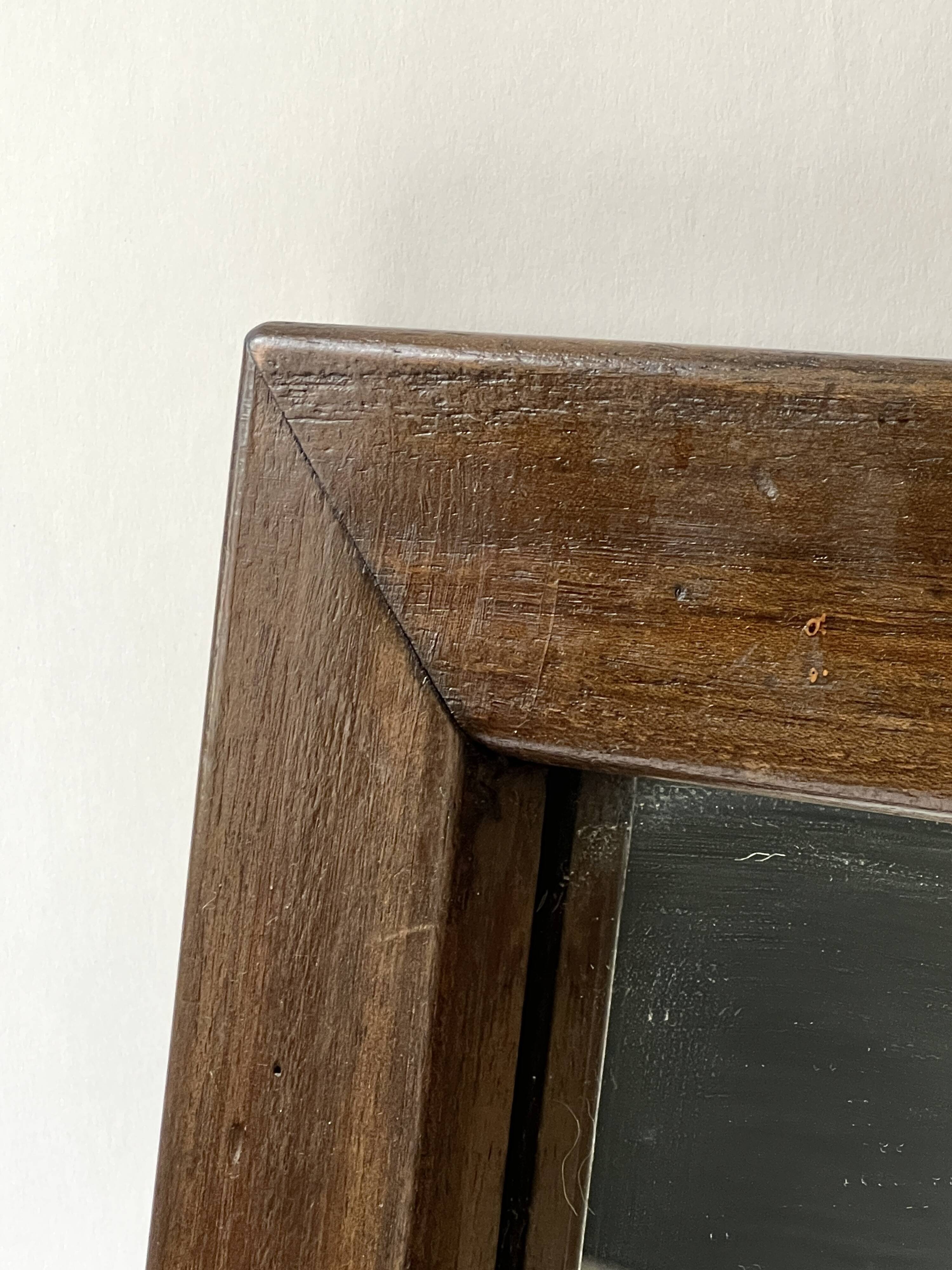 Brutalist rectangular wall mirror in solid wood, France 1950.
