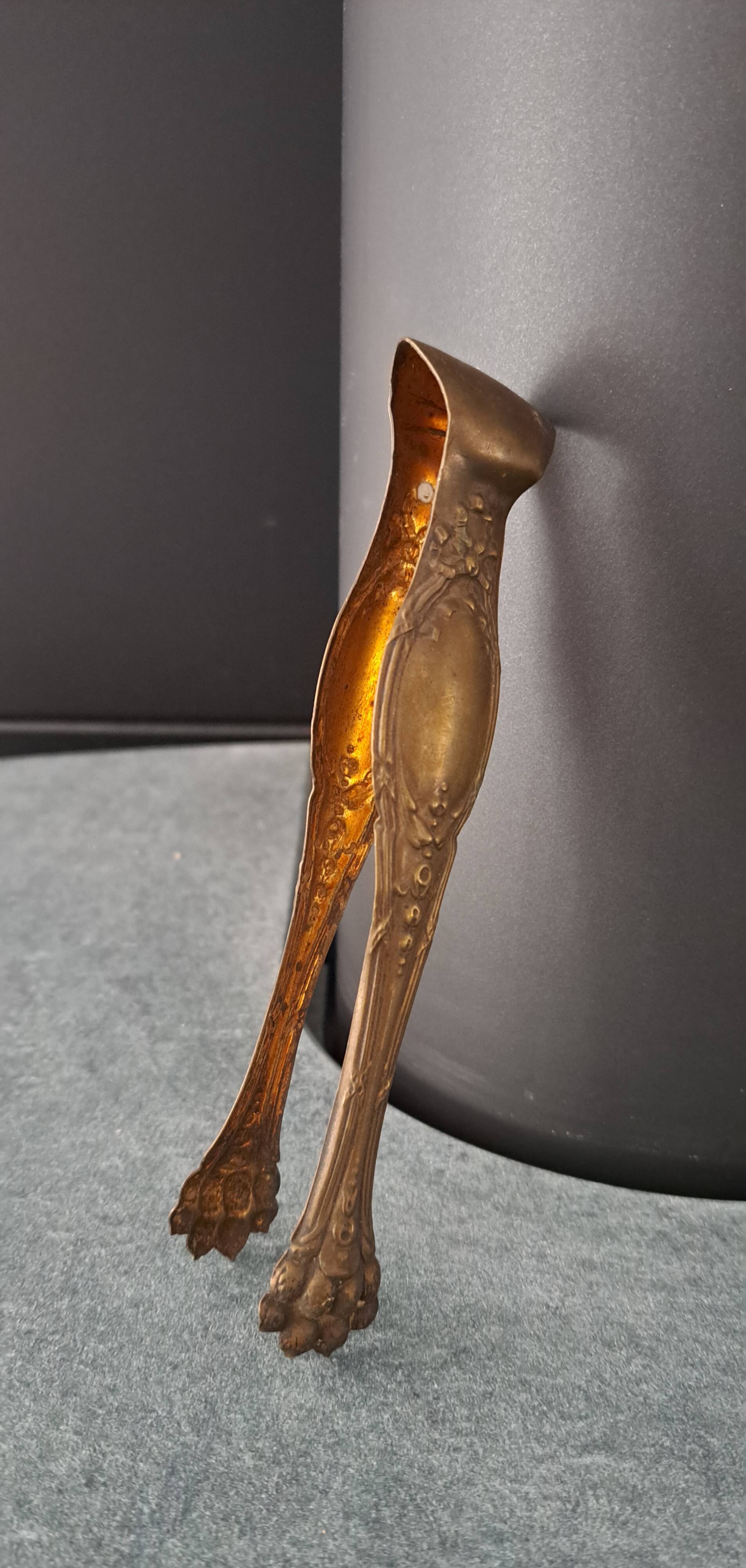 Antique sugar tongs with a system - Lion claws and Louis XV bow decoration.