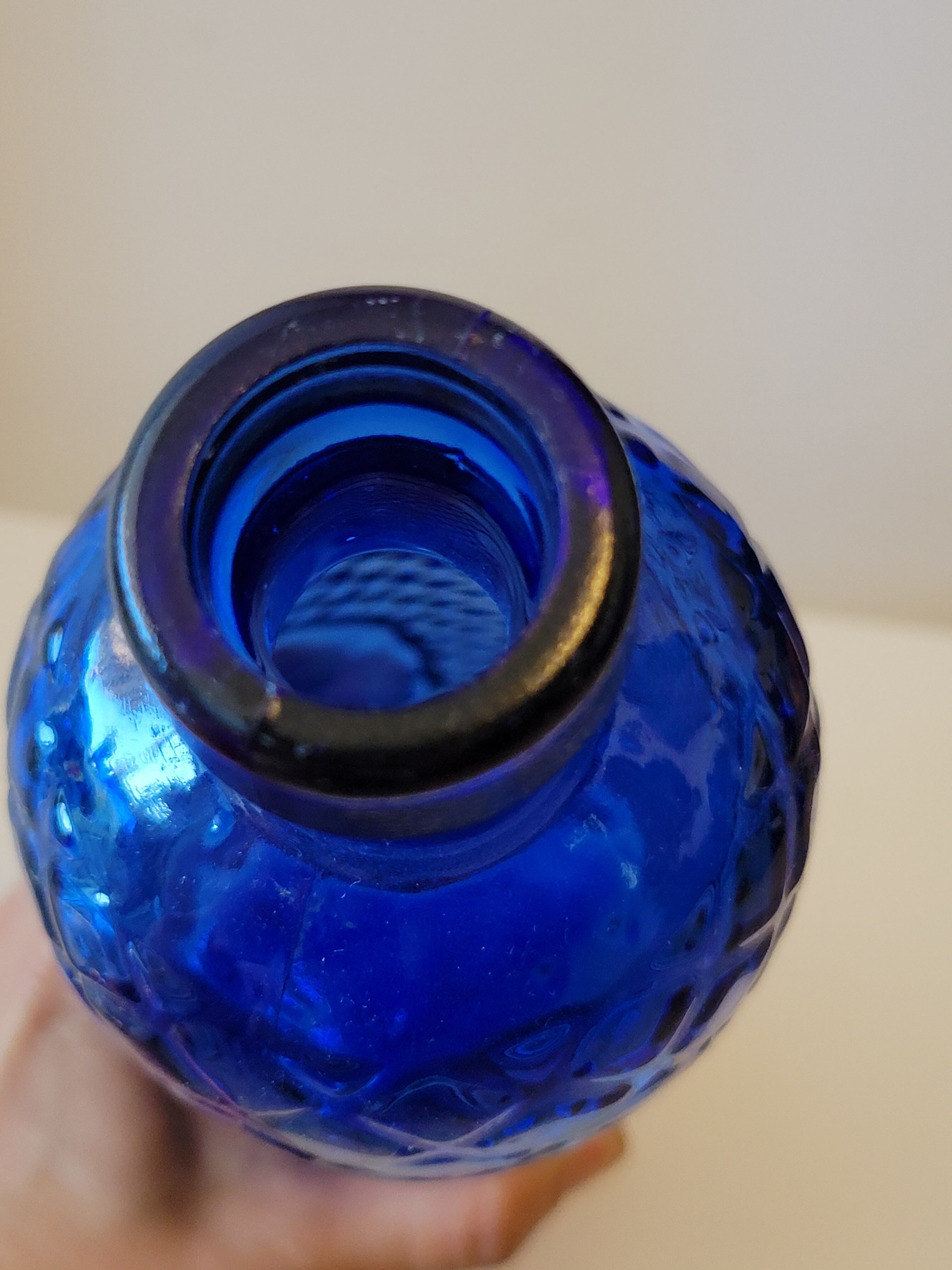 Vintage decanter bottle made of blue molded pressed glass