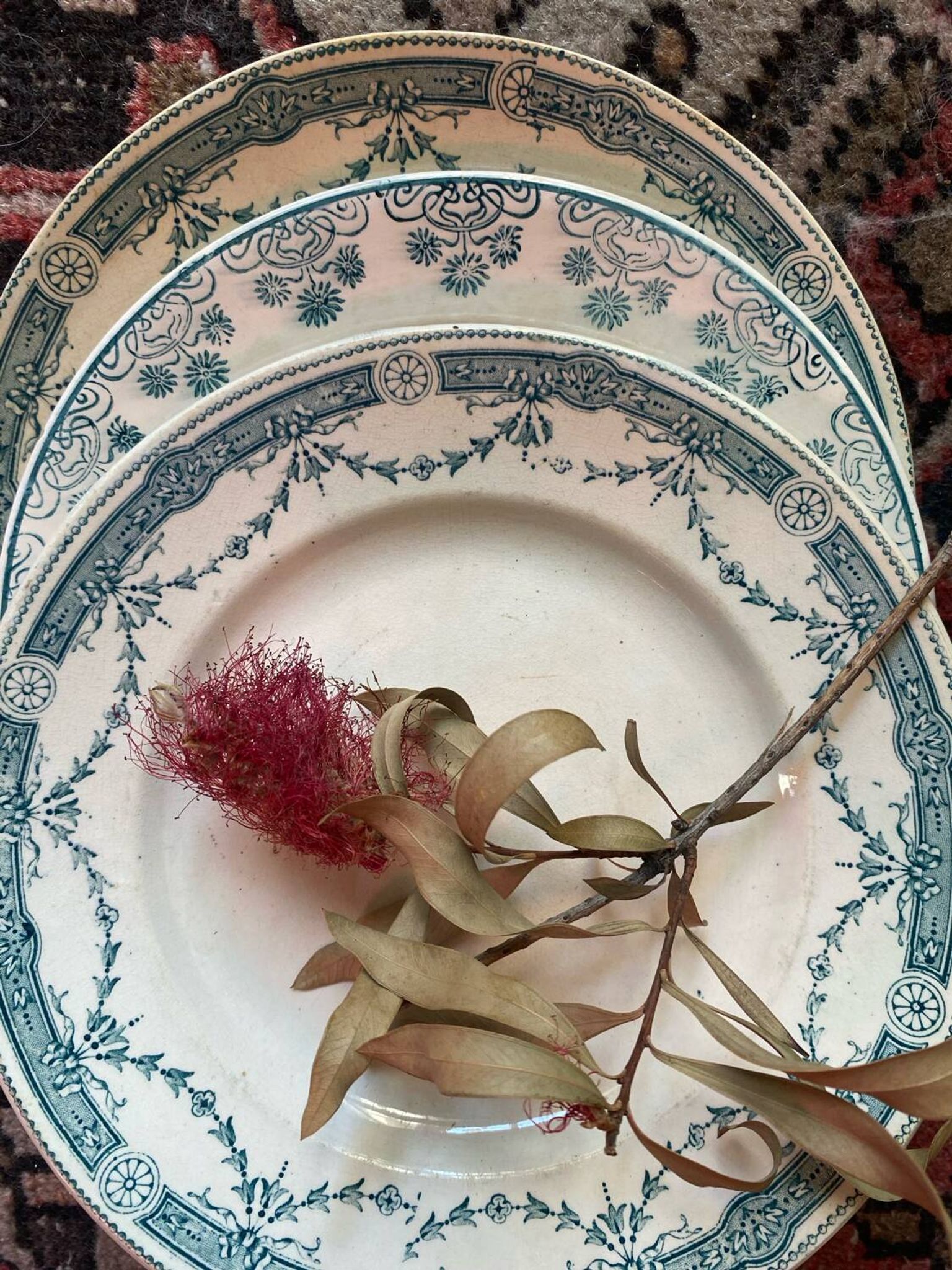 3 flat plates in ironstone with a green floral border