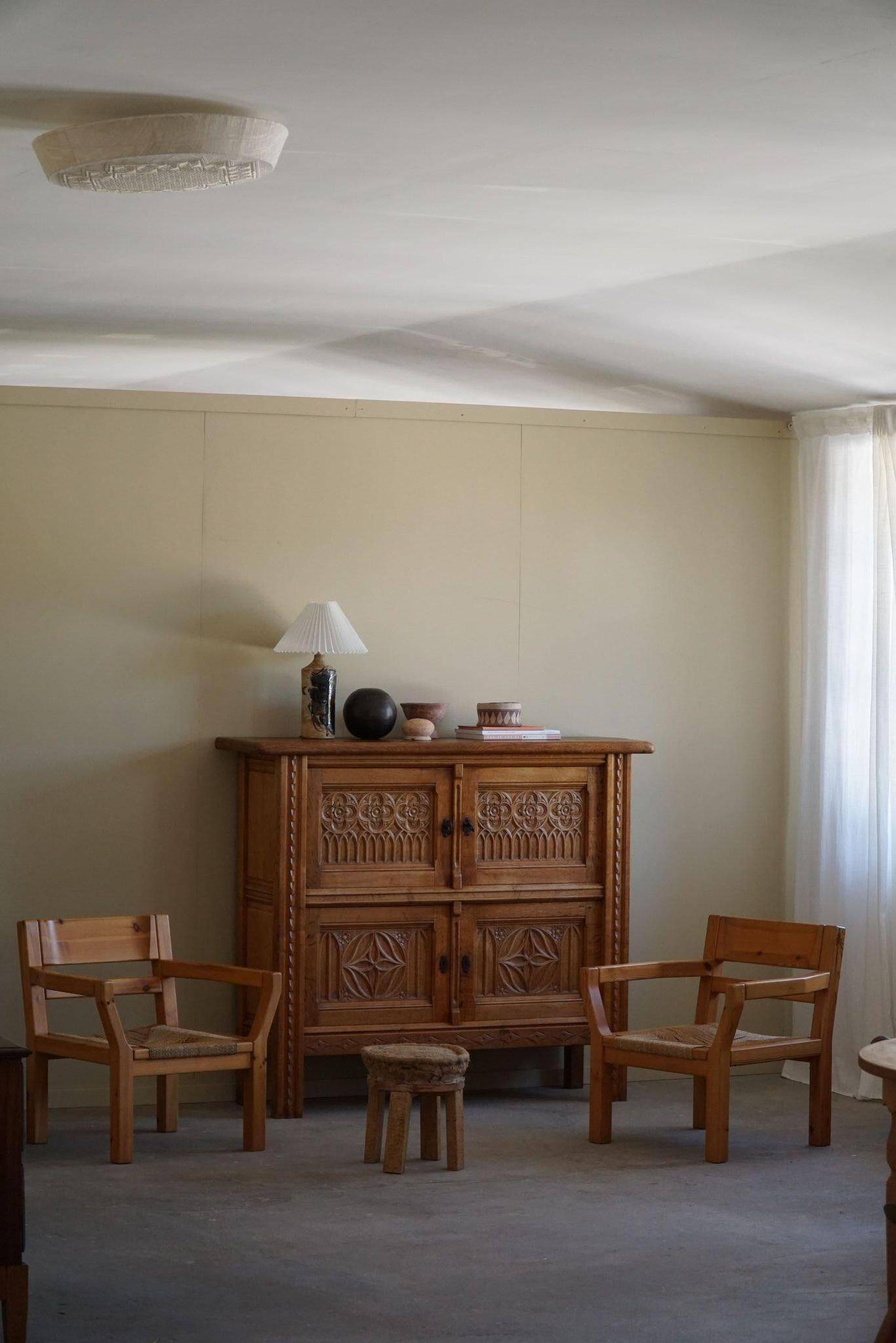 Tage Poulsen, a pair of brutalist chairs in pine and cord, Danish modern style, 1970s.