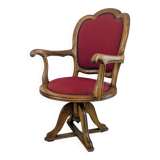 Vintage captain's chair in wood and garnet fabric — a seat with character
