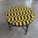 Round coffee table in yellow and black zellige, Moroccan graphic pattern.