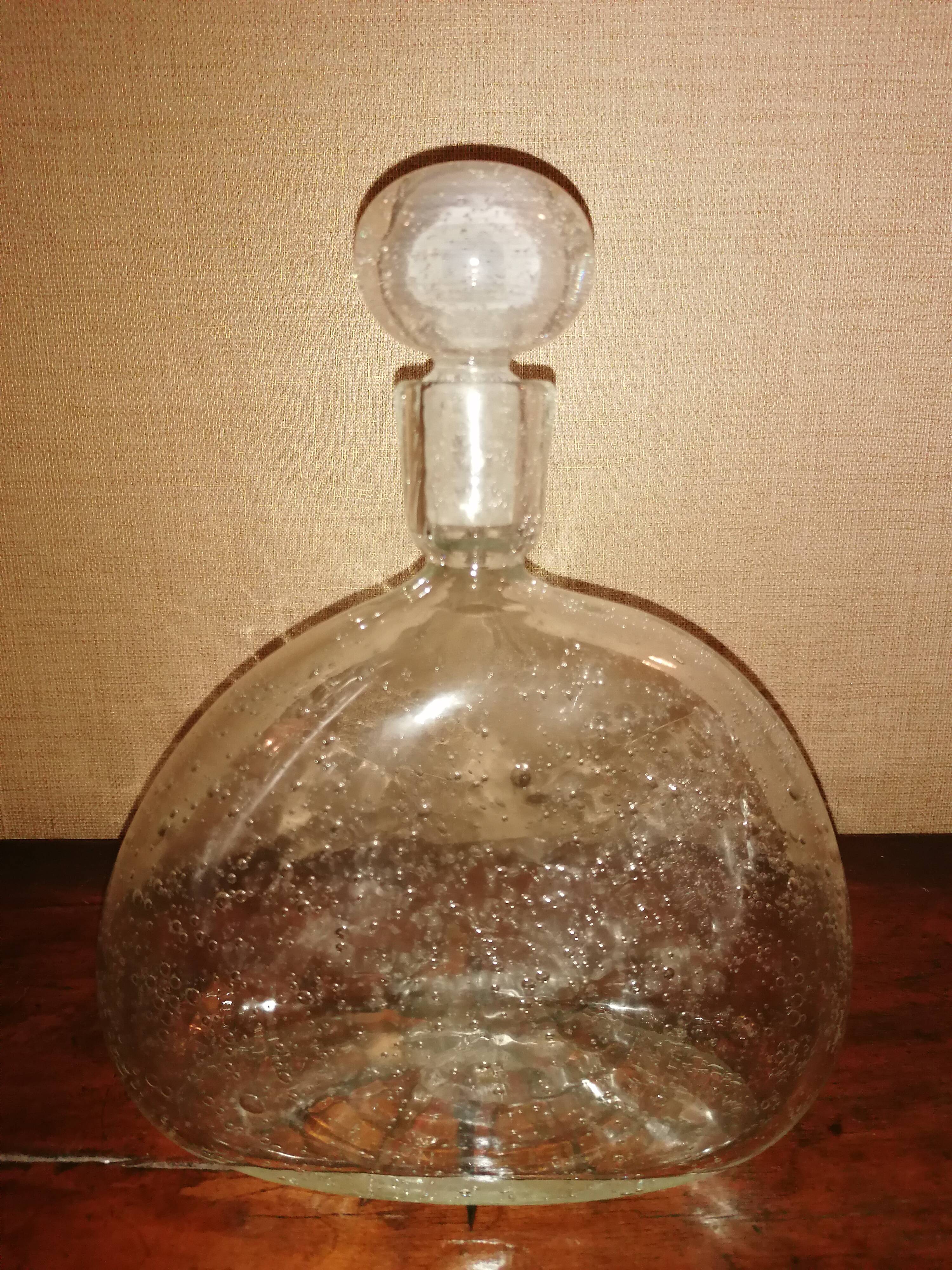 Clear bubble glass bottle molded for easy manual gripping