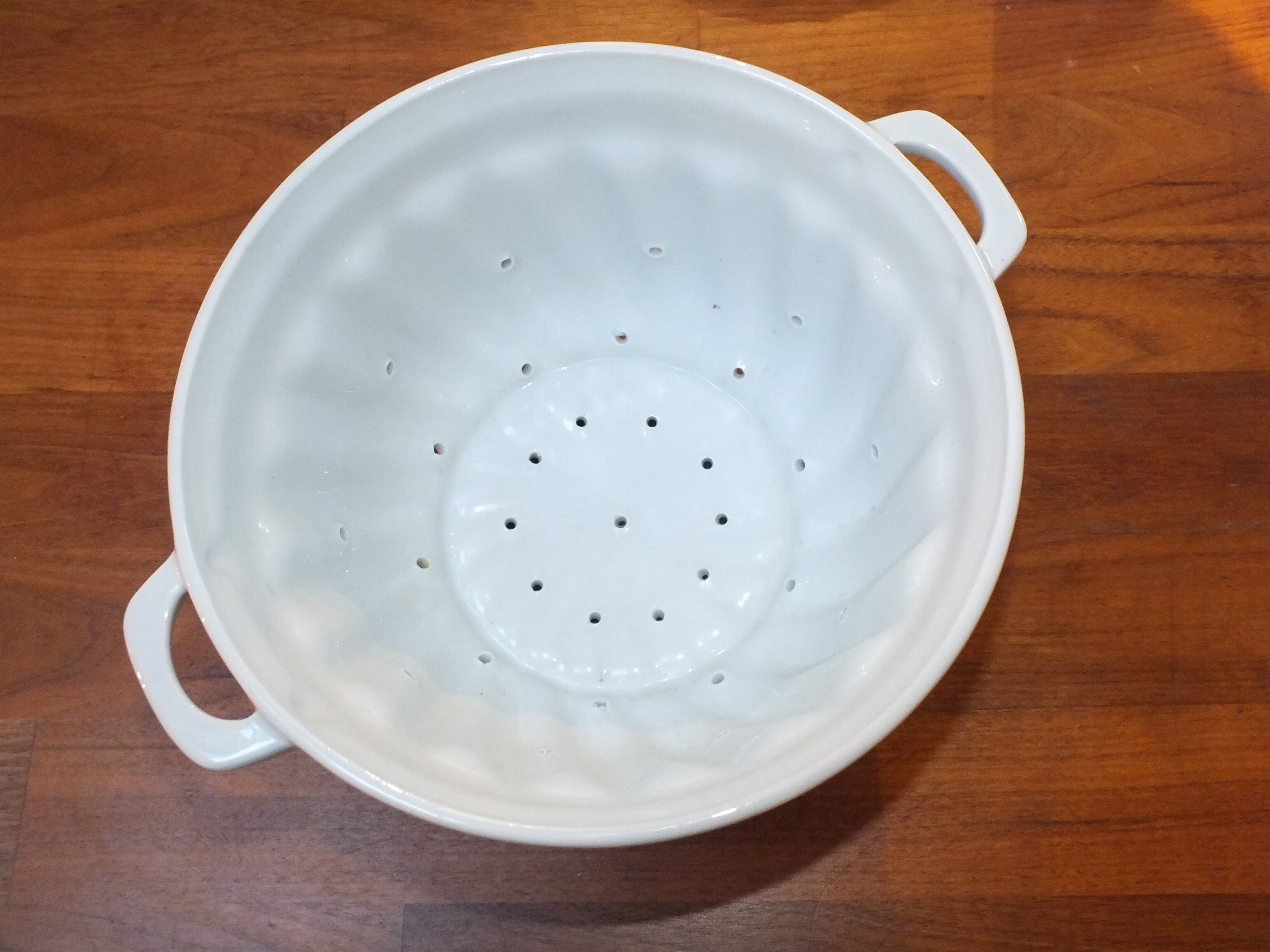 White porcelain strawberry strainer or drainer