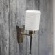 Brass wall light, black lacquered metal and white opal glass, 50s.
