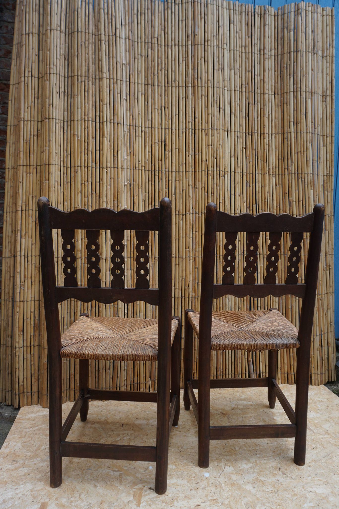 Pair of antique straw-seated farm chairs