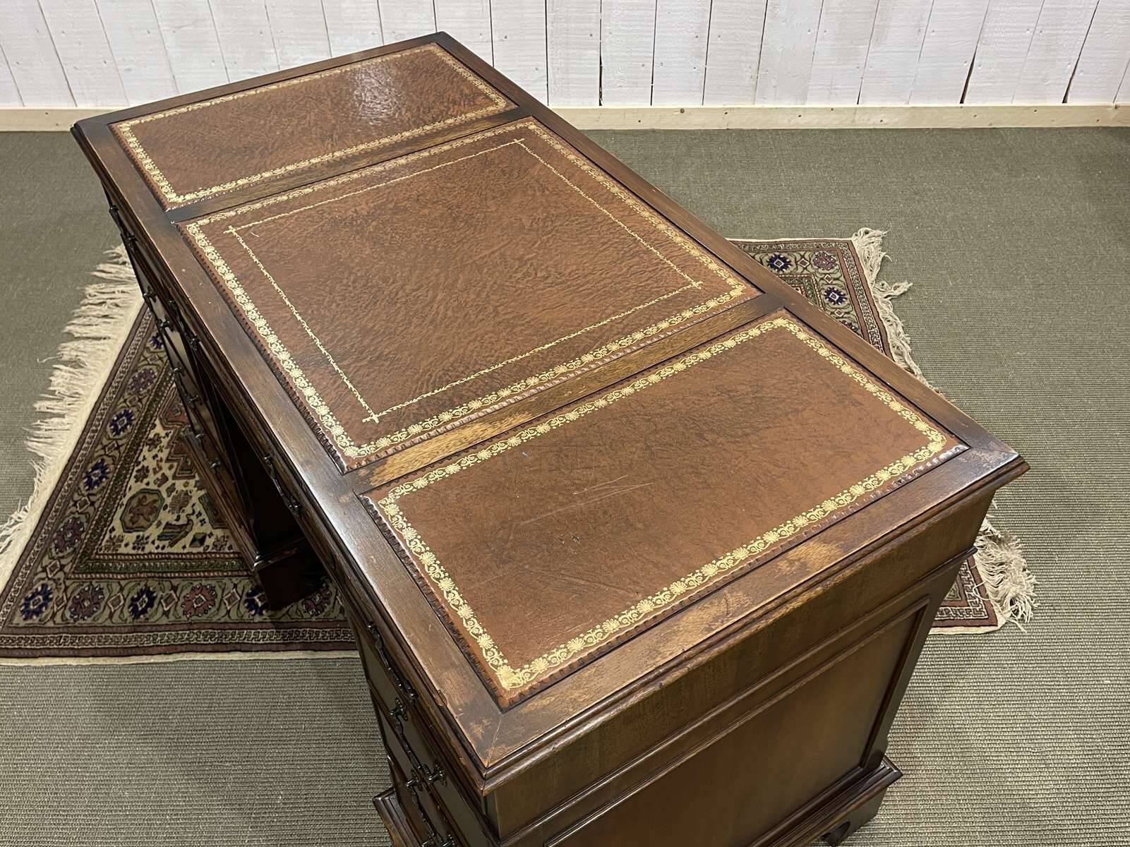 English mahogany pedestal desk with leather top from the 1950s