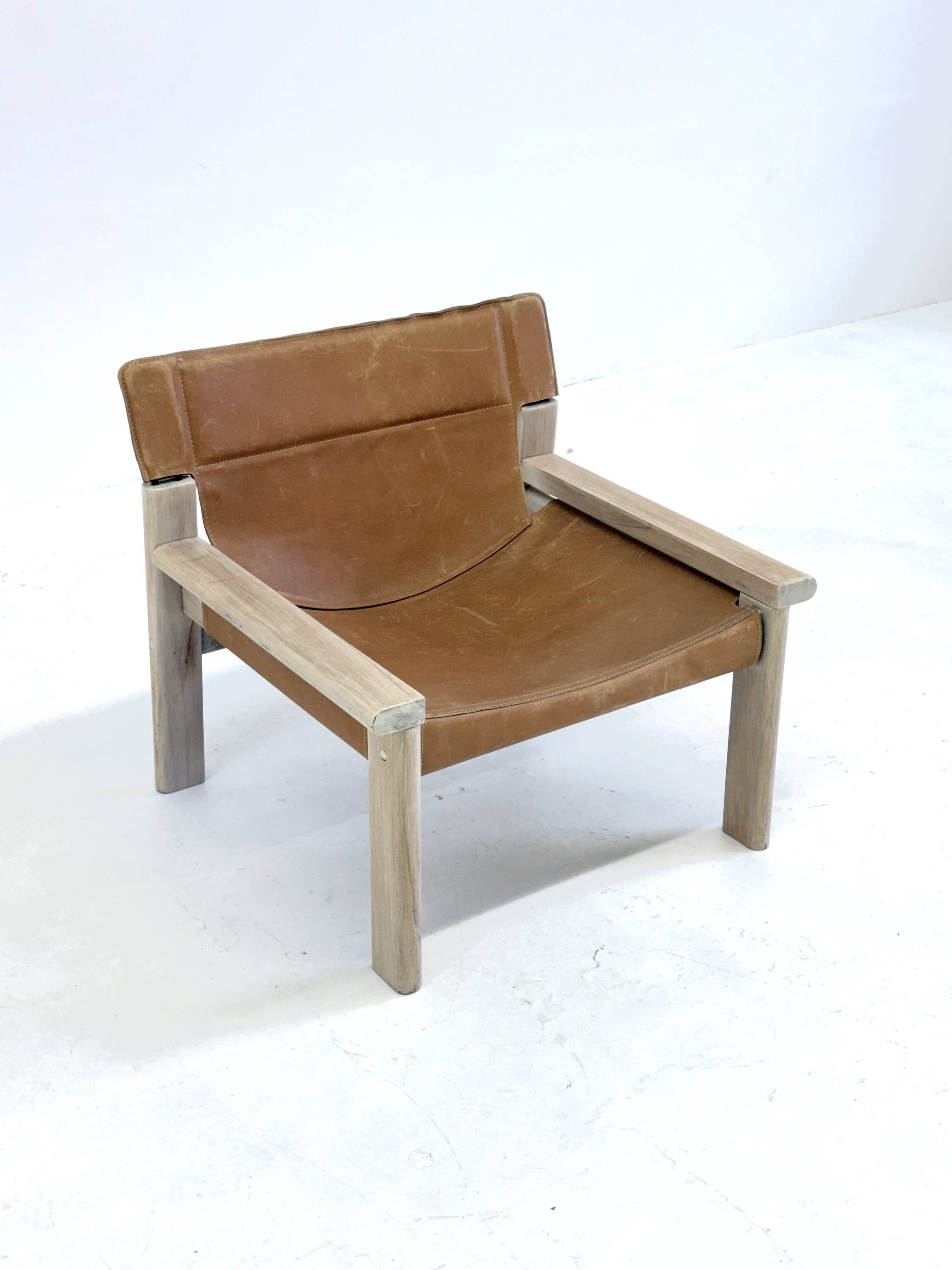Stylish vintage armchair with saddle leather seat