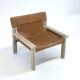 Stylish vintage armchair with saddle leather seat