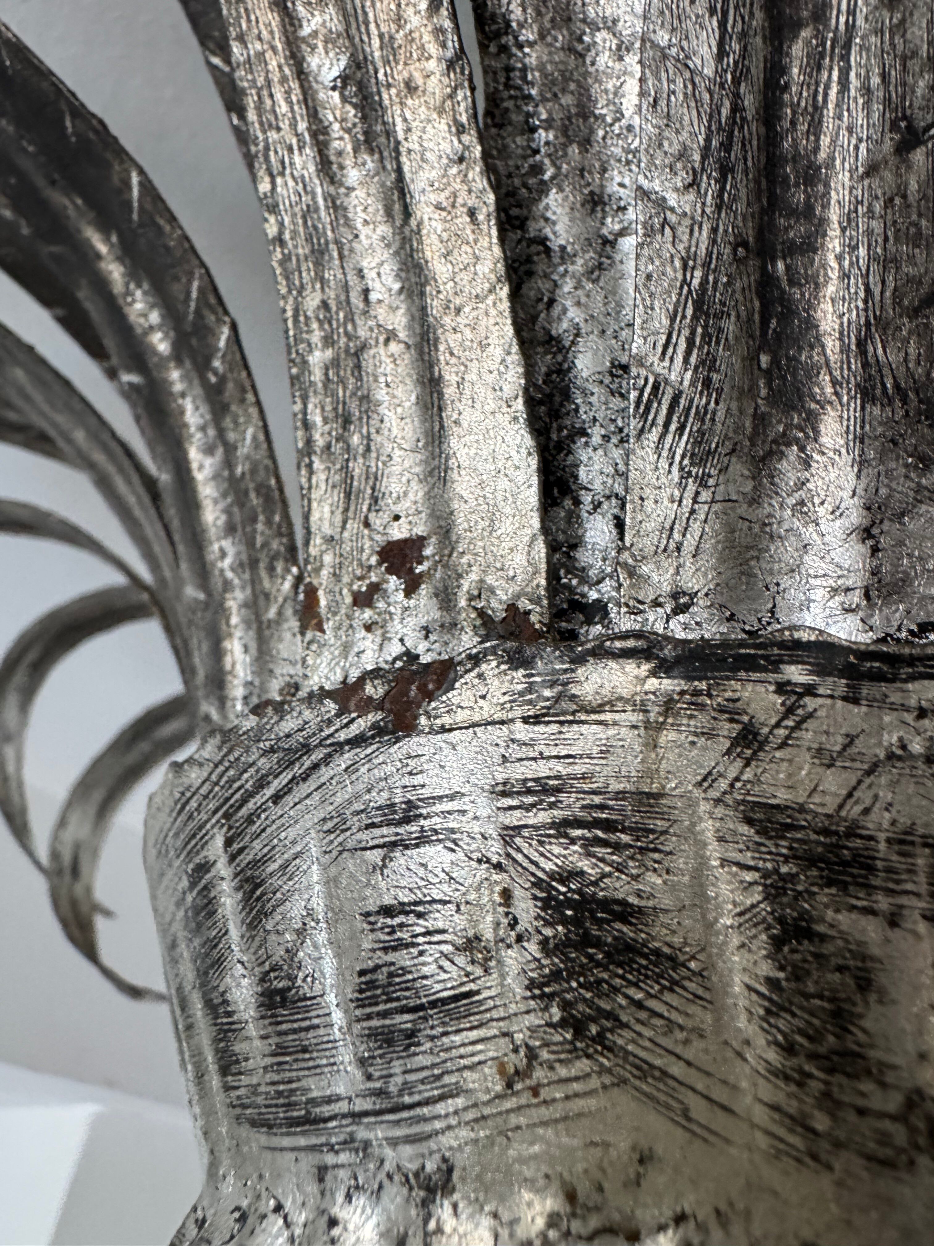 Silver wrought iron sunburst wall light from the 1960s.