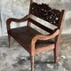 Small antique Indonesian bench in carved teak with plant and floral motifs.
