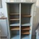 Vintage furniture transformed into a bookcase, verdigris patinated sideboard.